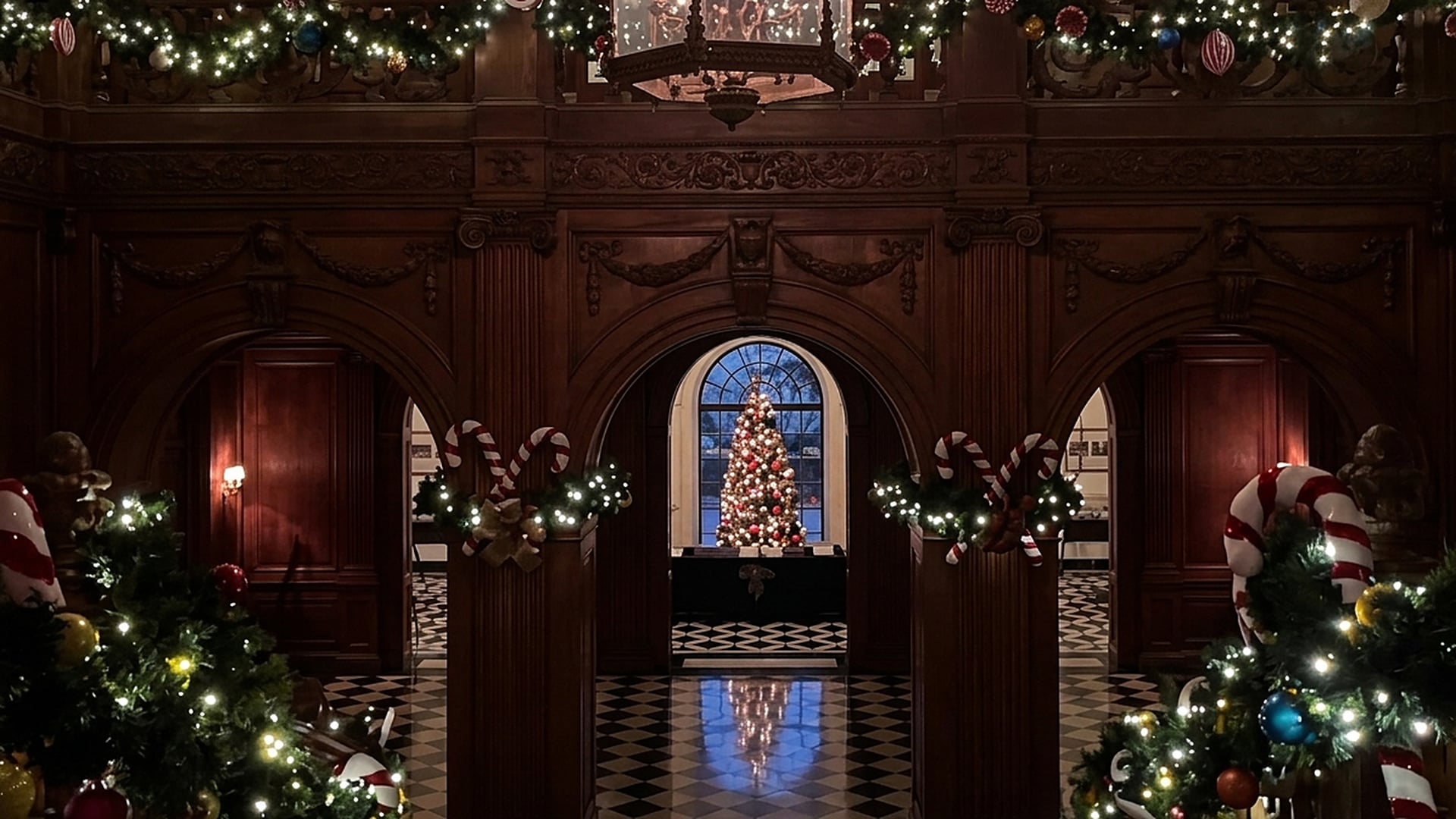 The grand hall of Greystone Mansion in Beverly Hills dressed for the holidays with garlands, candy canes and a lit Christmas tree
