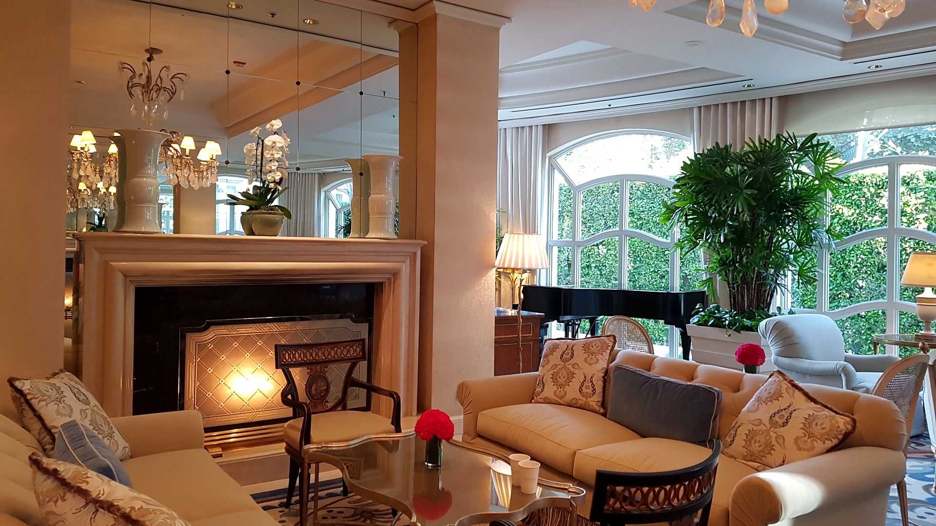 A fire lit in the fireplace of The Living Room at The Peninsula Beverly Hills