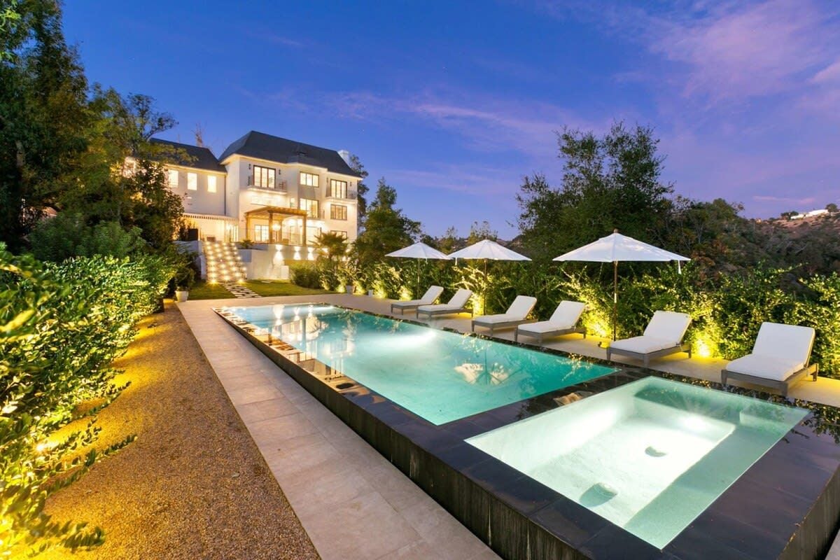 Pool, spa and twilight lights at Beverly Hills Maison, a French country style Stay Awhile home in Beverly Hills